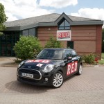 Black RED car infront of RED driving school